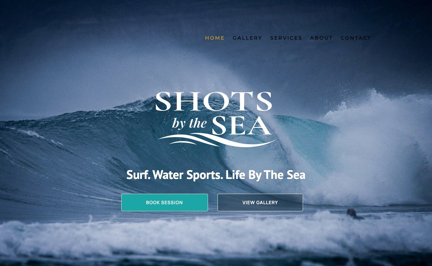 Shots by the Sea homepage on a laptop: full-bleed wave photograph with the wordmark and Book Session and View Gallery buttons